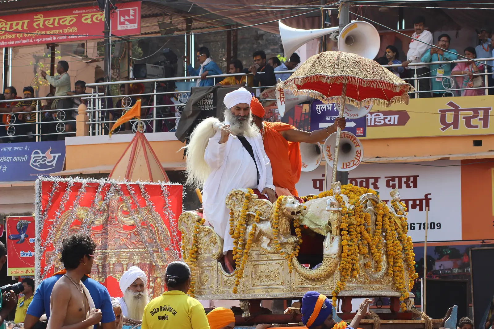 उज्जैन, 2016: निर्मल अखाड़े के जुलूस में फूलों से सजी पालकी पर चंवर लिए सफेद पगड़ी वाले एक साधु