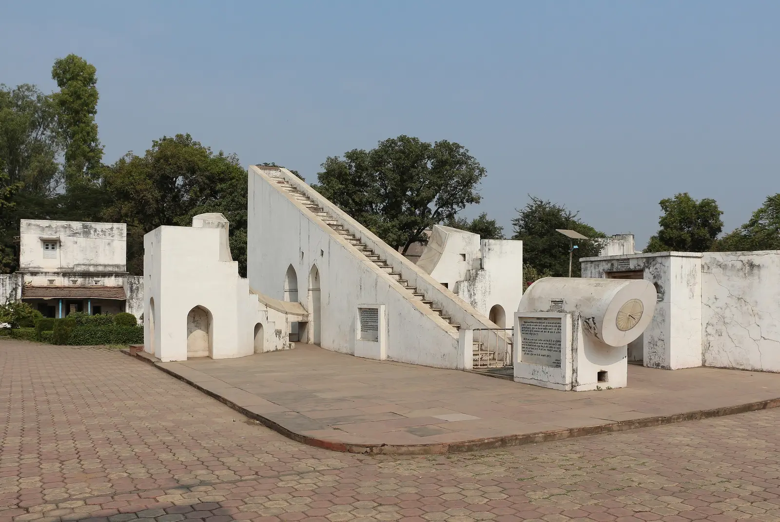 White masonry astronomical instruments, including a large sundial with a staircase, at the Ved Shala observatory in Ujjain
