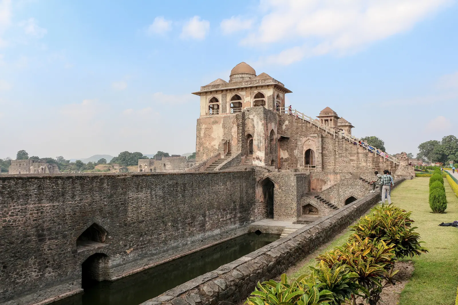Jahaz Mahal palace in Mandu, with its long stone water channel and a garden alongside