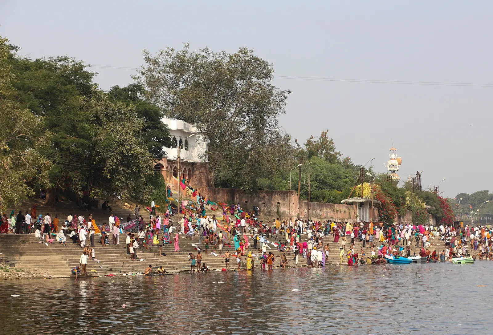 Pilgrims crowding the stone steps of Ram Ghat on the Shipra river in Ujjain, seen from the water